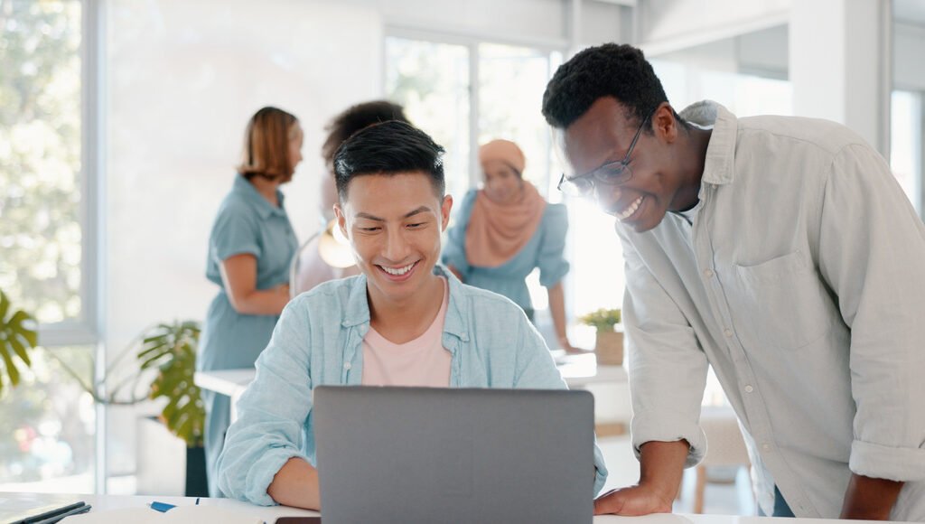 fist-bump-success-and-people-on-laptop-in-office-t-LBKEZR6
