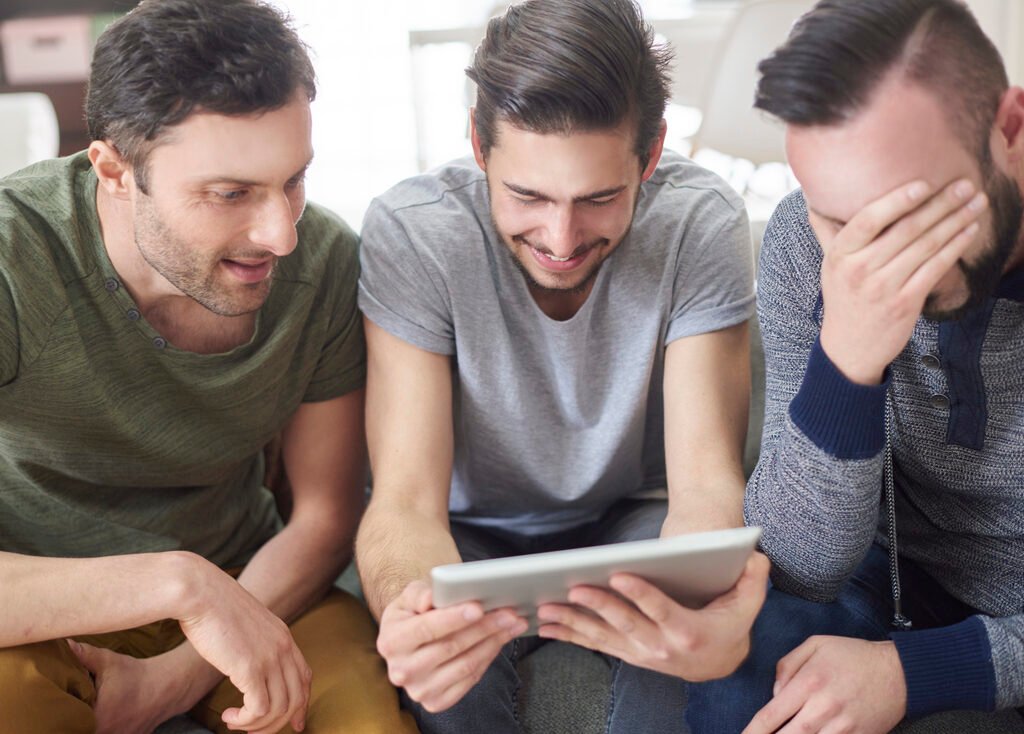 Friends browsing photos from their old times